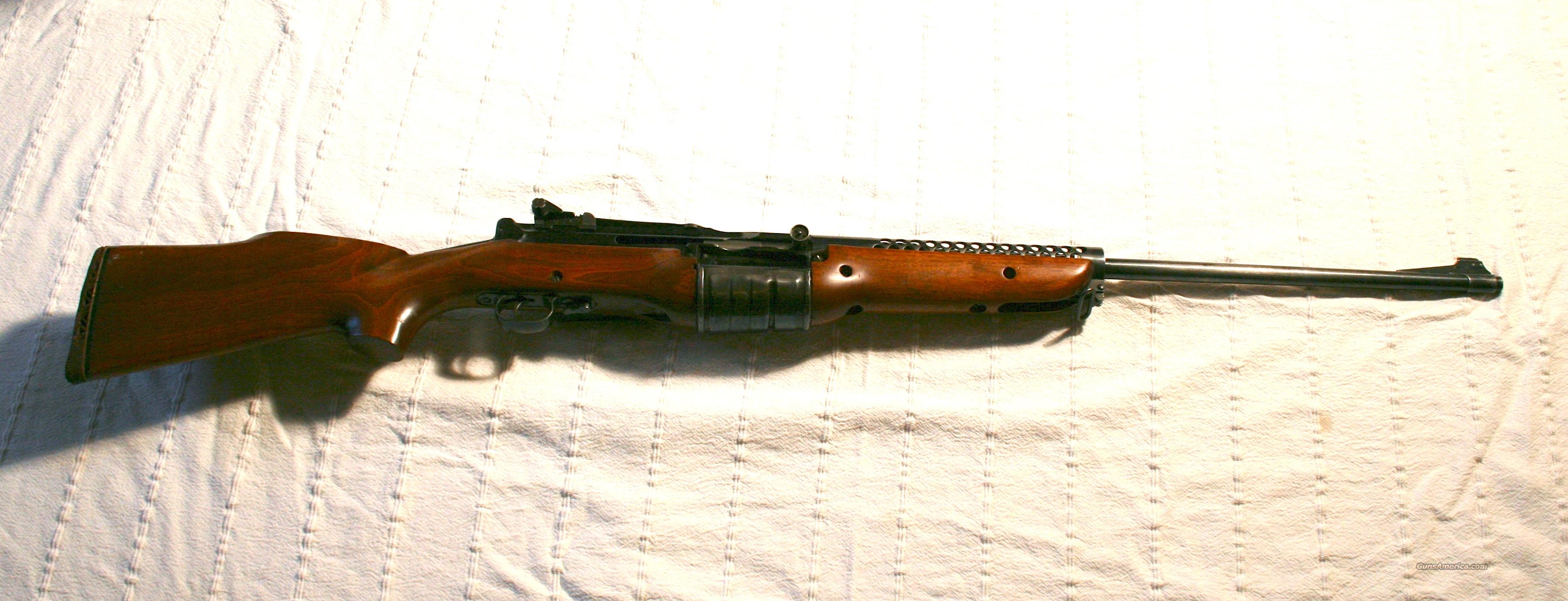 Which World War II-era rifle has a barrel which reciprocates (moves backward) with every shot?